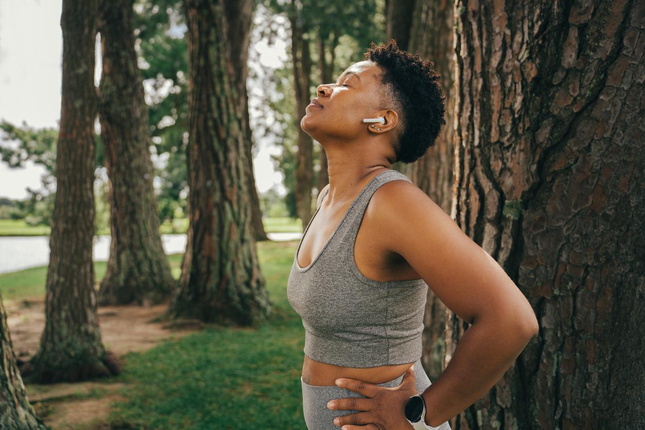 Woman relaxing after finishing exercise in the park